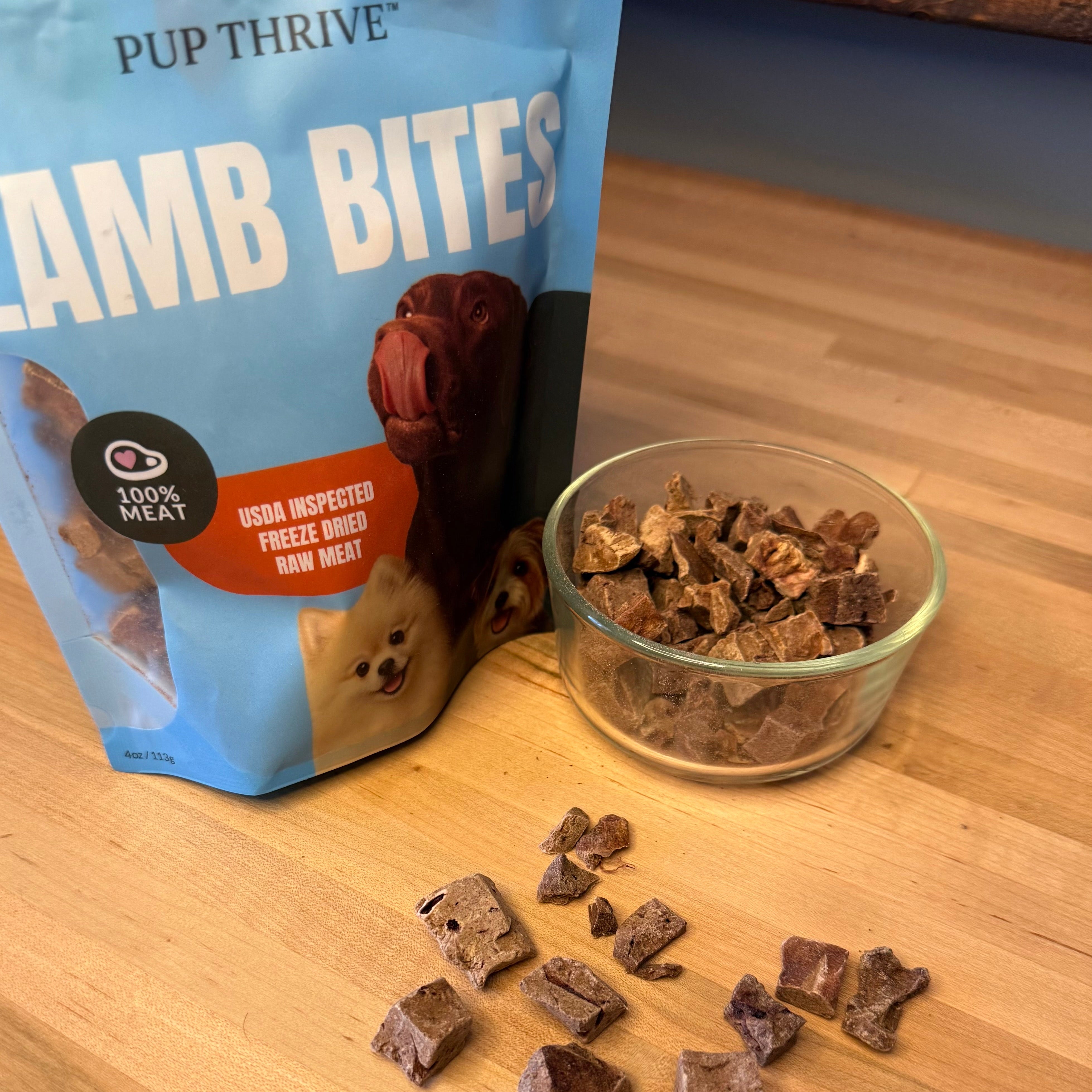 A closeup shot of the 100% Lamb Bites on a natural wood desk.