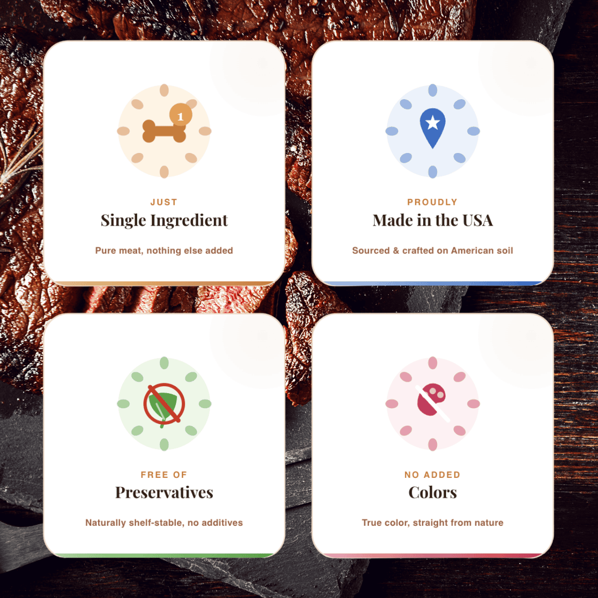 Four cards with icons and text about food ingredients on a wooden surface. The cards advertise that the 100% Meat Bites are single ingredient, made in the USA, free of preservatives, and contain no added colors.
